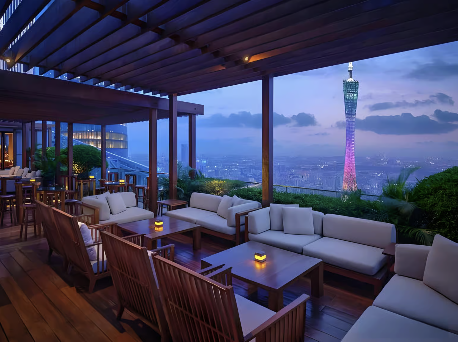 Guangzhou skyline view from a 70th floor rooftop bar at sunset