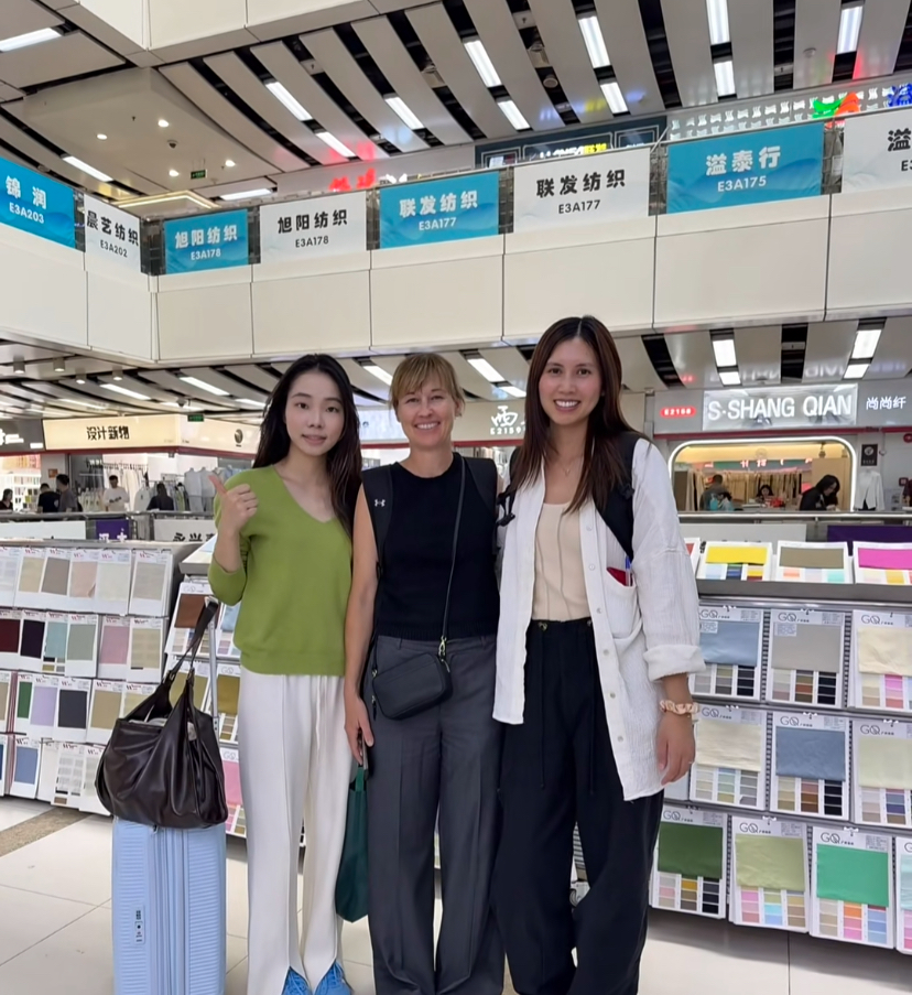 Guangzhou textile market — rolls of fabric and busy stalls
