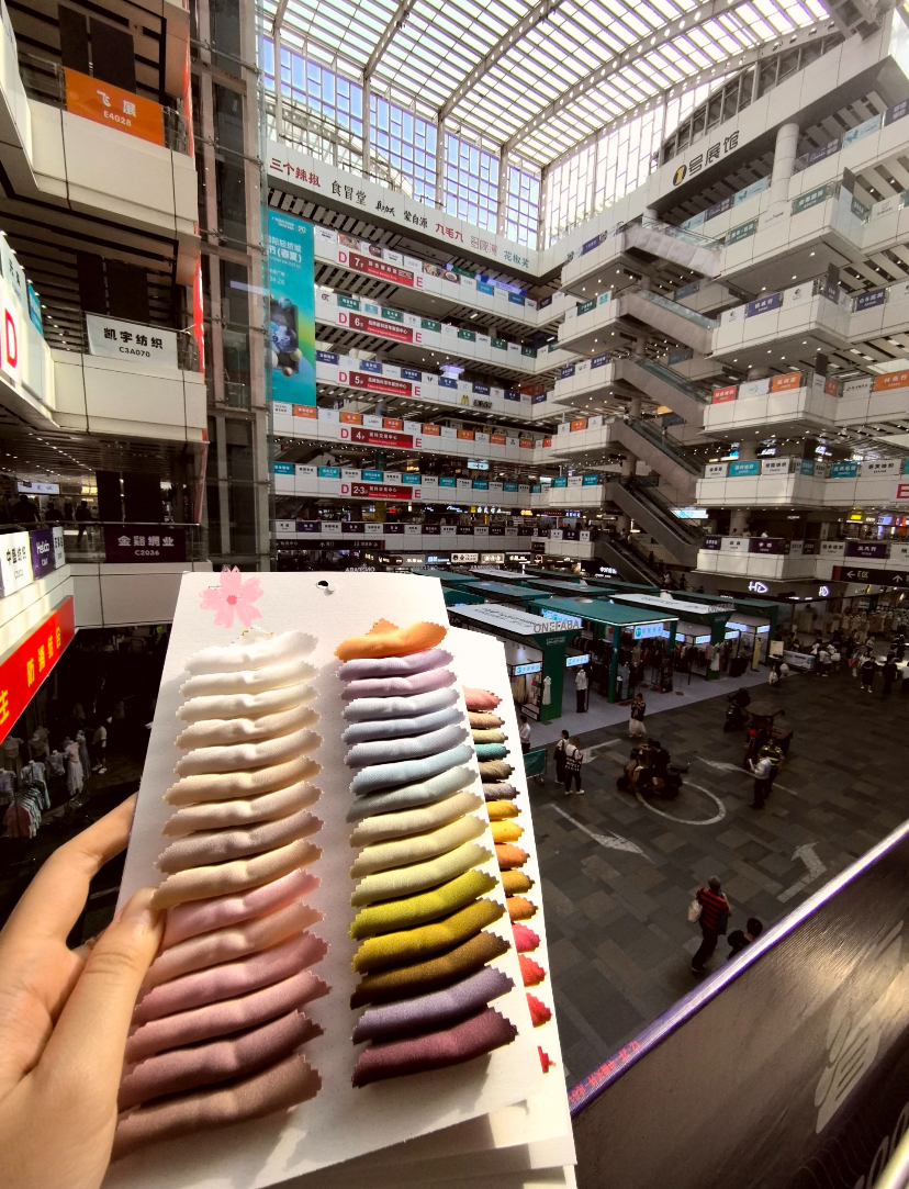 Bolts of colorful cloth stacked at the market